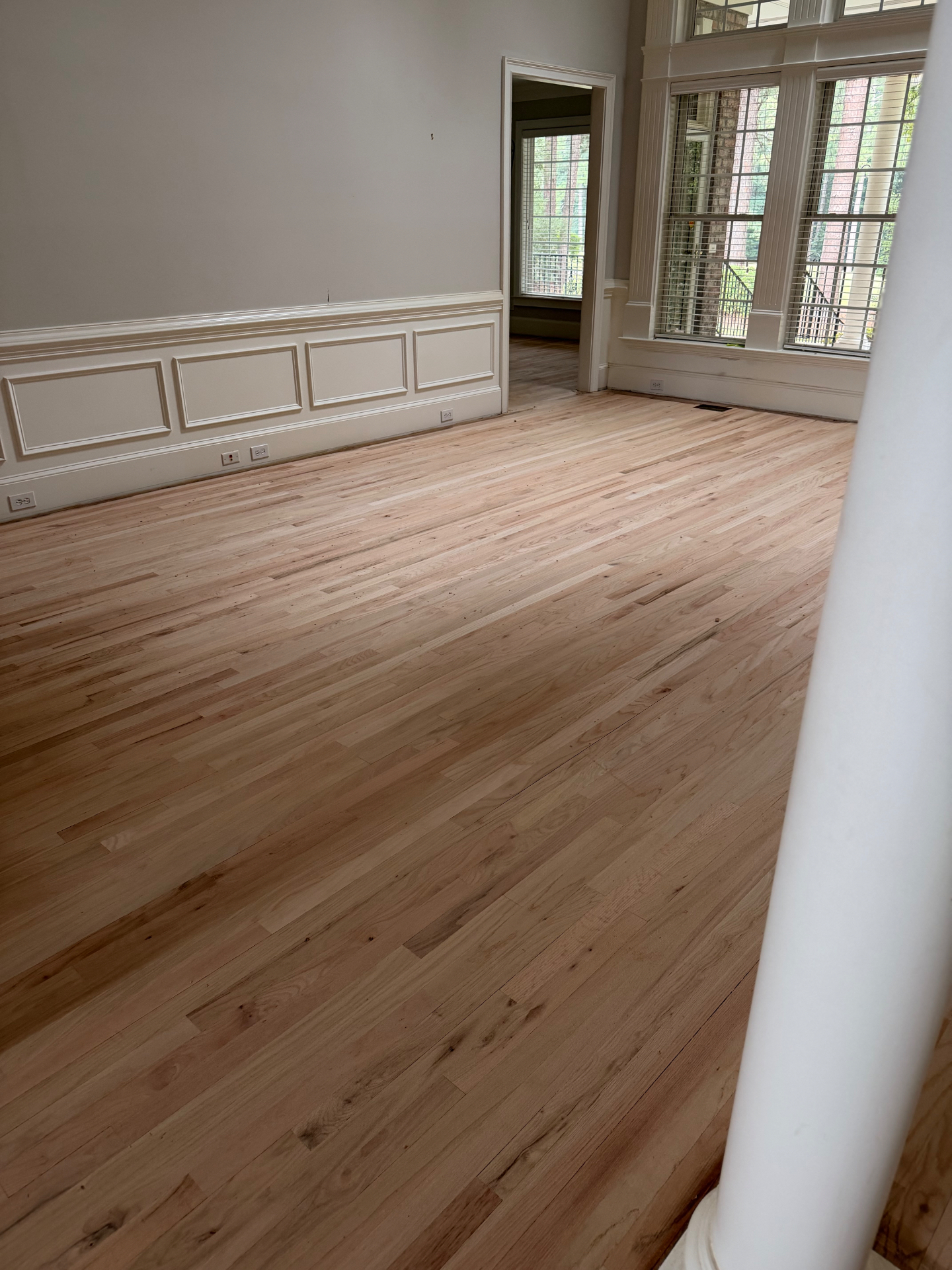 Freshly sanded natural oak flooring in a formal living room